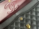 a black purse with a gold chain on it