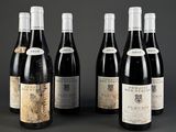 six bottles of red wine are lined up in a row