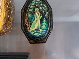 three decorative items hanging on the wall next to each other