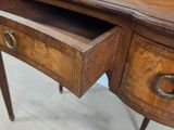 a wooden desk with a mirror on top of it