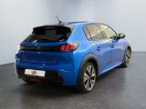 the rear end of a blue car with its trunk open