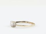 a close up of a diamond ring on a white background