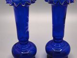 two blue vases that are sitting on a table