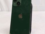 a green iphone sitting on a stand on a white surface