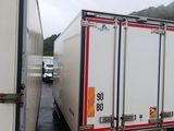 two trucks that are parked next to each other