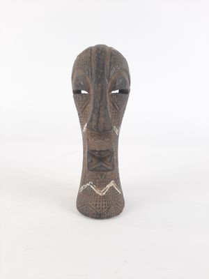 an image of a wooden sculpture of a face on a white background