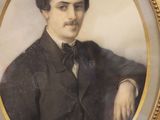 portrait of a man in a suit and bow tie in a gold frame