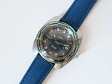 a close up of a wrist watch on a white surface