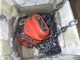 a box with chains and a red bag in it