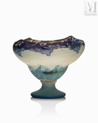 a blue and white vase sitting on top of a table