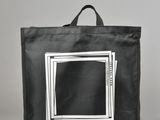 an image of a black bag with a picture of a tv inside of it