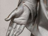 a statue of a man holding his hands out