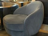 a chair and a table in a room with wood paneled walls