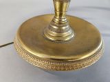a gold lamp that is on top of a table