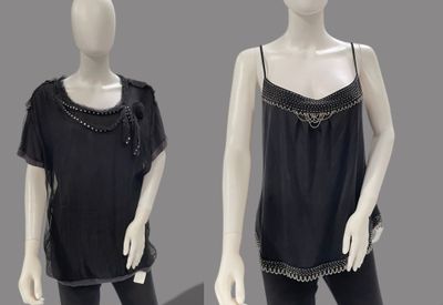 two mannequins dressed in black clothing with chains on them