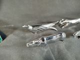 three silver figurines sitting on top of a cloth