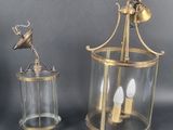 pair of brass and glass hanging lanterns on a grey background