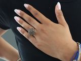 a woman that is wearing a ring on her finger