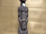 an old wooden statue of a man holding a baby in his arms