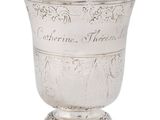 a silver cup that is sitting on a stand