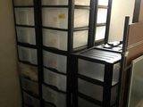 a stack of plastic containers sitting on top of a shelf