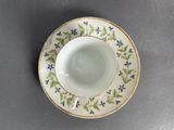 a small cup and saucer on a table