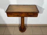 a small table with a wooden top on a tiled floor