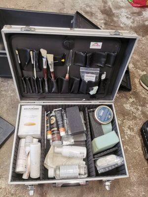 a suitcase full of tools sitting on the floor