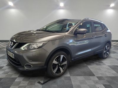 a grey nissan qx parked on a checkered tile floor
