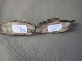two pairs of shoes with tags on them sitting on a chair