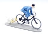 a figurine of a man riding a bike with a cat on the back