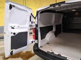 a white van with its doors open in a garage
