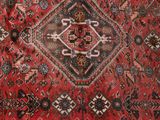 an image of a red oriental rug with a diamond design on it