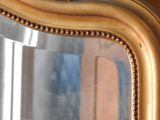 a close up of a mirror with a reflection of a building in the background
