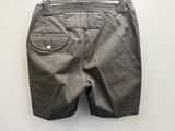 the back view of a pair of gray shorts hanging on a hanger