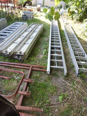 two ladders that are sitting in the grass