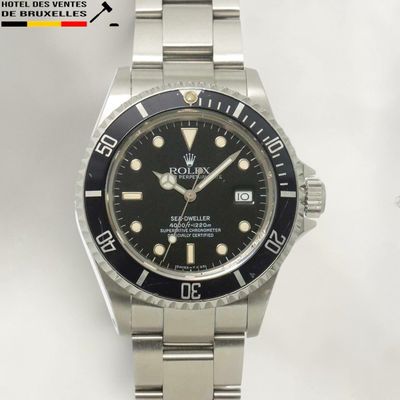 a rolex watch with a black dial on a bracelet