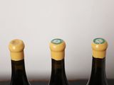 three bottles of wine sitting on top of a table next to each other