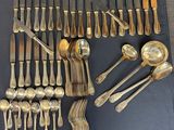 a lot of silverware on a tray on a table
