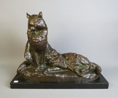 bronze statue of a cat and a dog on a black base