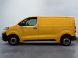 the yellow van is parked on the concrete floor in the room