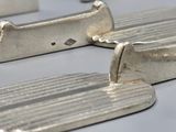 four pieces of silver that are on a table