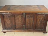 an old wooden chest with ornate carvings on the top