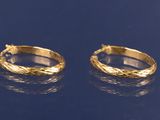 deux paires de boucles d'oreilles créoles en or sur un fond bleu