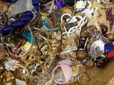 a wooden box filled with lots of jewelry and scissors