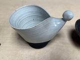 a small bowl and a small bowl sitting on a table