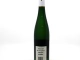 the bottle of wine is sitting on a white surface