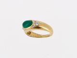 a gold ring with a green stone and a diamond