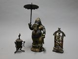 une statue représentant un éléphant tenant un parapluie, à côté d'autres objets