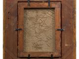 an old wooden picture frame with a picture hanging on the wall